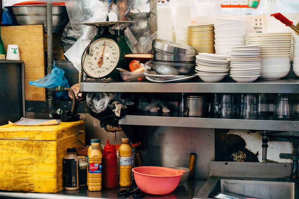 Vibrant kitchen scene in Seoul with assorted bowls, scales, and condiments creating a bustling atmosphere.