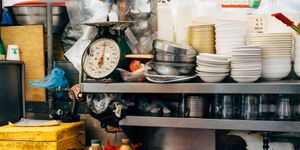 Vibrant kitchen scene in Seoul with assorted bowls, scales, and condiments creating a bustling atmosphere.